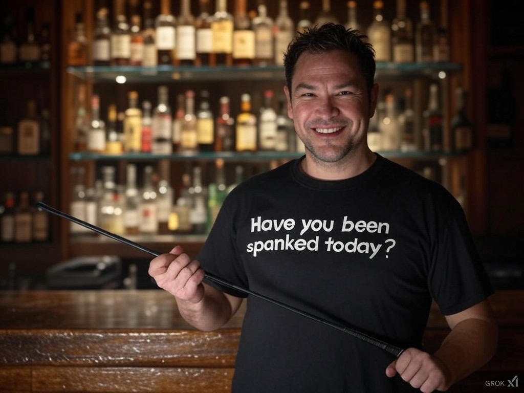 A man holding a cane wearing a t-shirt saying Have you been spanked today?